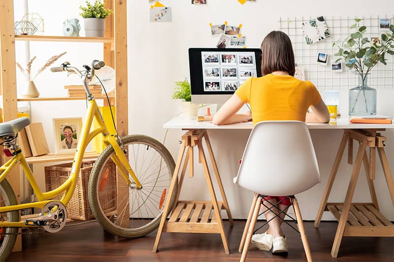 Image of girl working in garden room office - Urban Garden Sheds